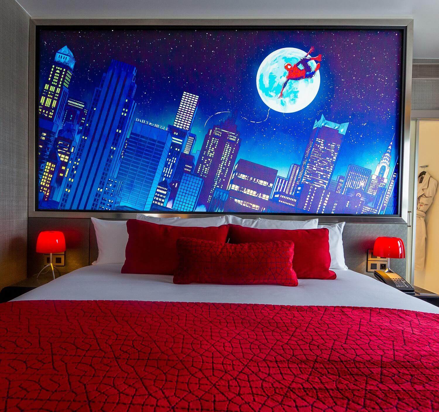 Spider-Man Suite sleeping area A picture with Spider-Man over the rooftops of New York at night over the bed