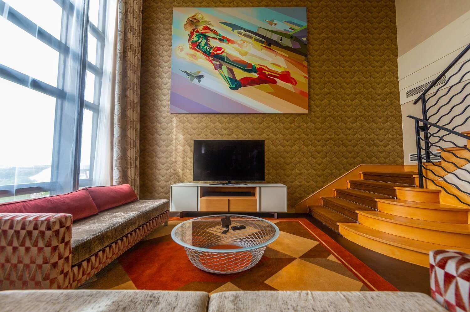 Presidential Suite The seating area of the suite with sofas, table and TV, next to it a staircase leads up to the sleeping area