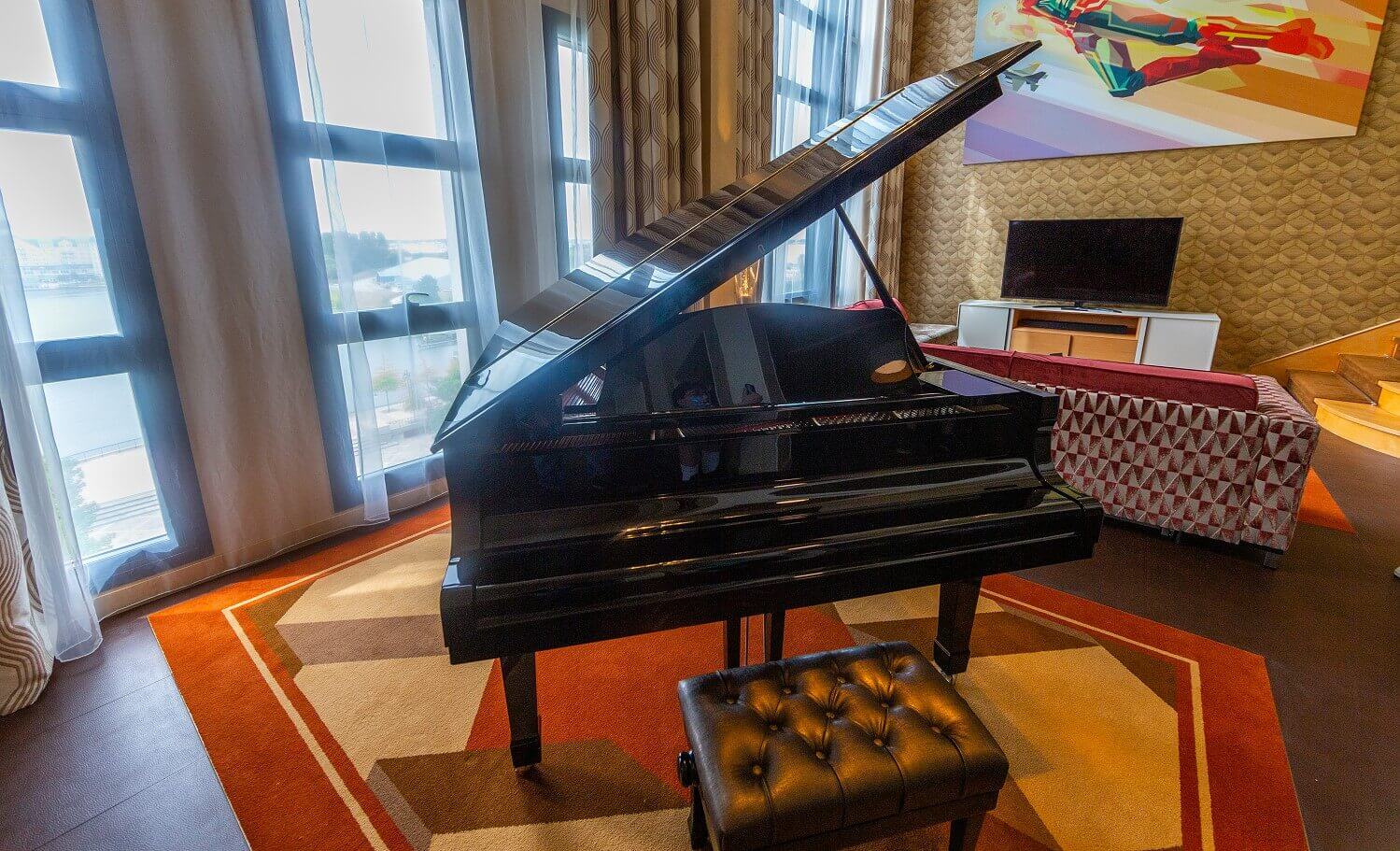 Presidential Suite A black piano in the suite