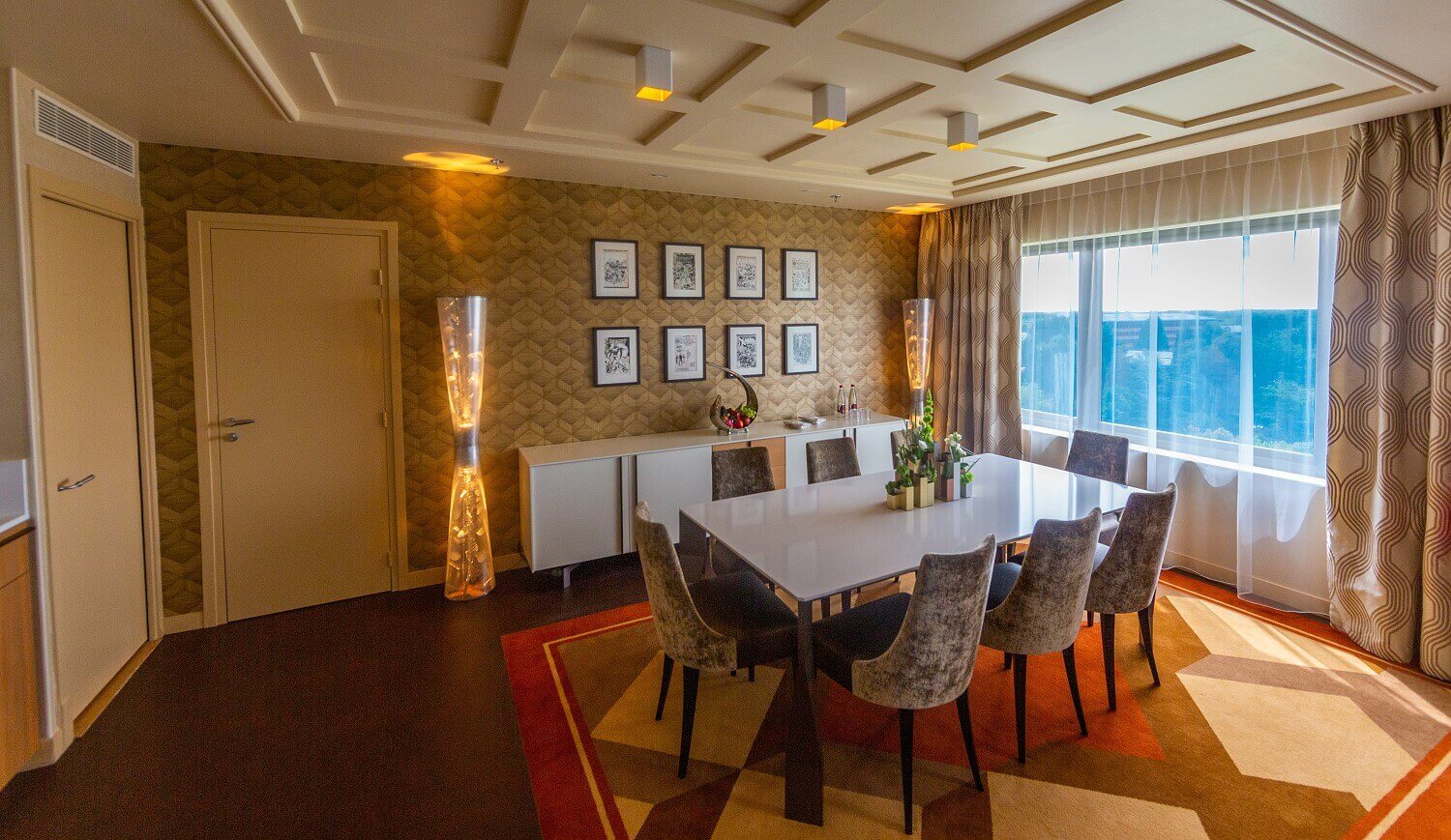 Presidential suite seating area The seating area of the Presidential Suite, a large table with 8 chairs, on the wall next to the sideboard are futuristic lamps