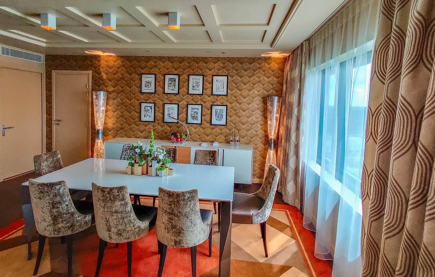 Presidential suite seating area A decoration made up of several small flower vases can be seen on the large table in the suite, while Marvel works of art hang on the wall