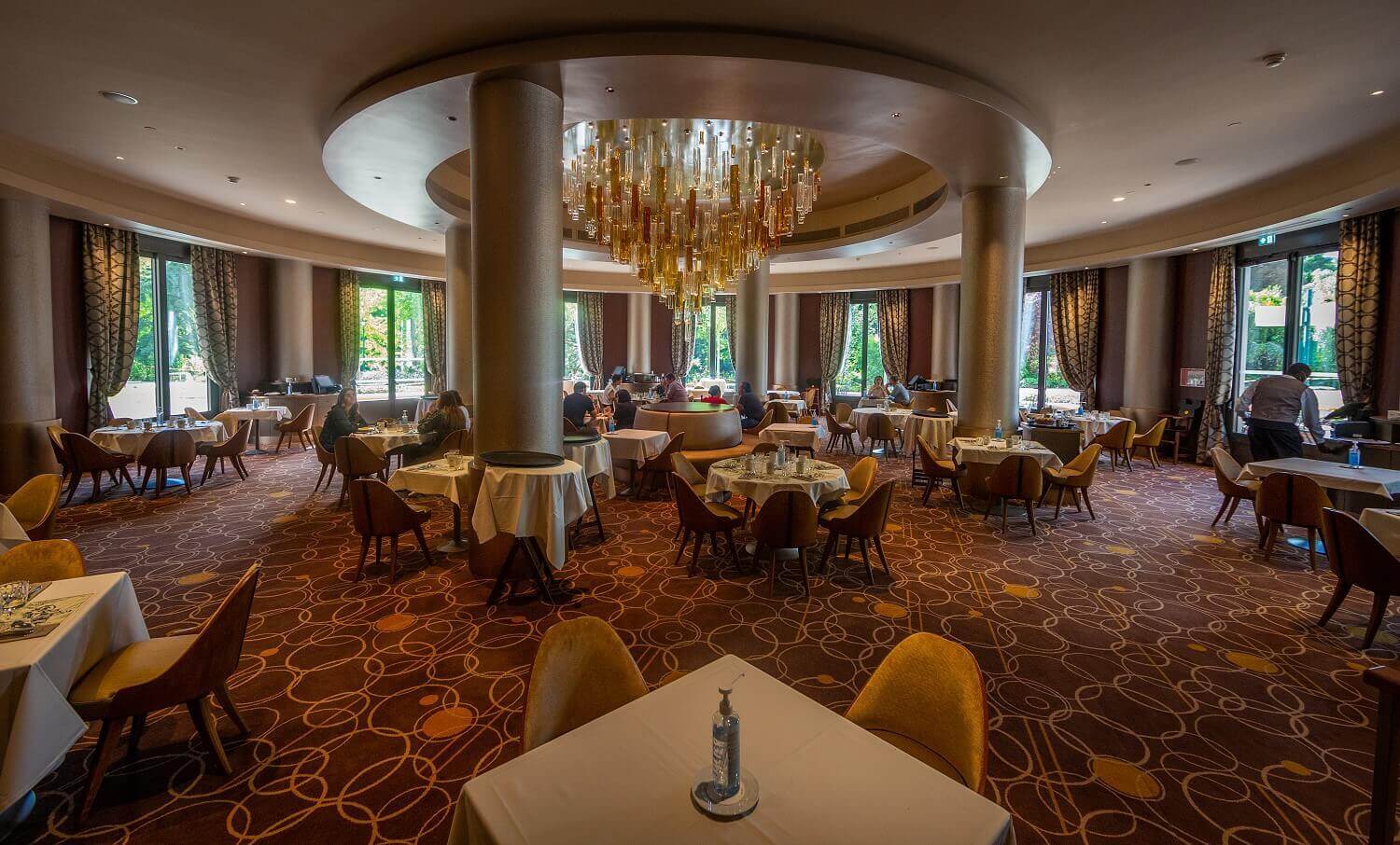 Dining room Manhattan Restaurant The dining room in the Manhattan Restaurant, with an imposing glass chandelier in the middle of the room.