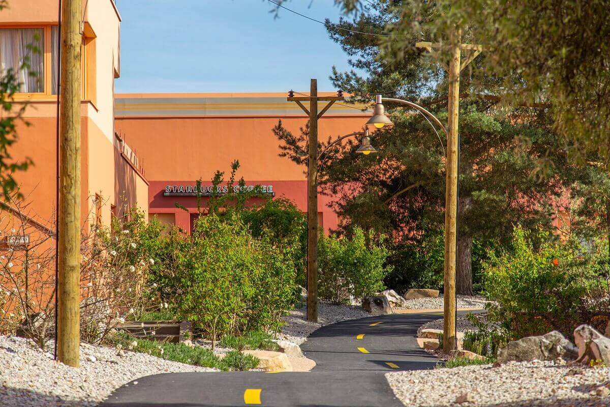 Santa Fe Hotel Building with Route 66 Route 66 winds through the Mexican-looking landscape with hotel buildings. Behind it a Starbucks Cafe.