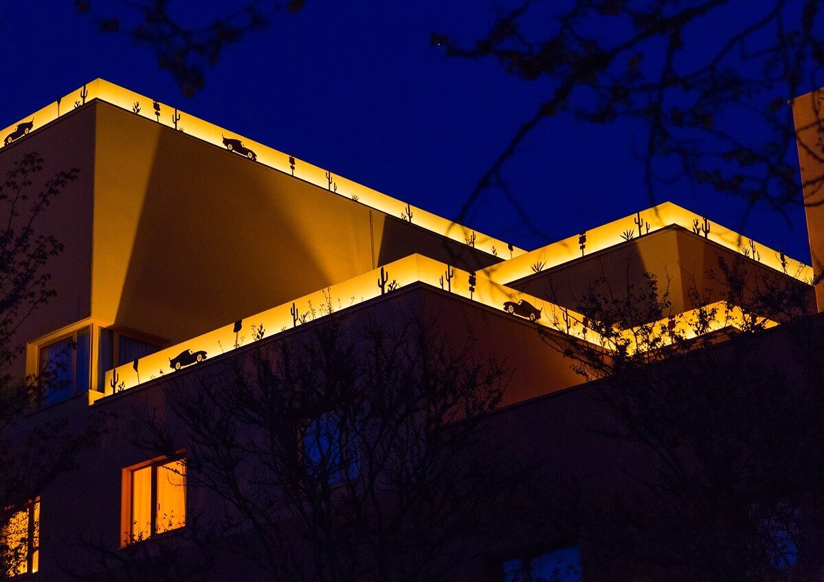 Hotel building Santa Fe by night A hotel building illuminated at night. On the roofs are illuminated borders with motifs from the movie Cars.