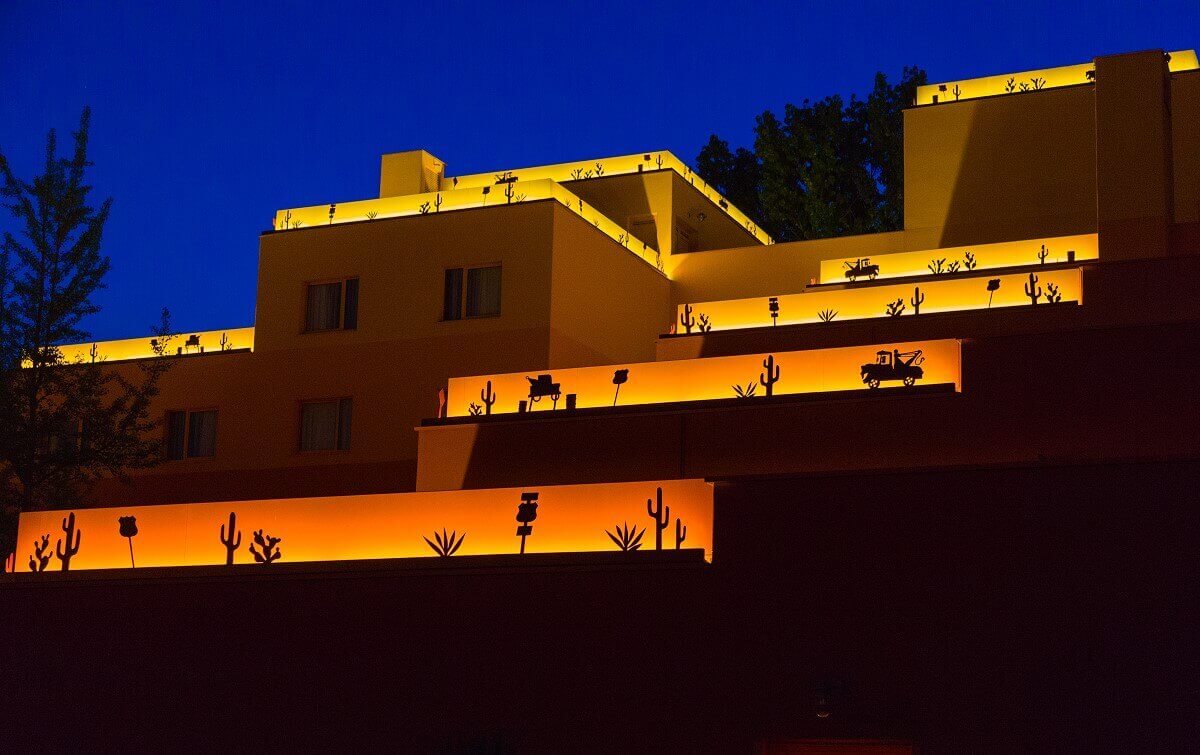 Hotel building Santa Fe by night A hotel building illuminated at night. On the roofs are illuminated borders with motifs from the movie Cars.