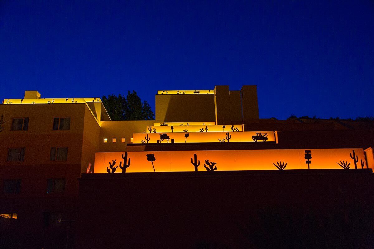 Hotel building Santa Fe by night A hotel building illuminated at night. On the roofs are illuminated borders with motifs from the movie Cars.