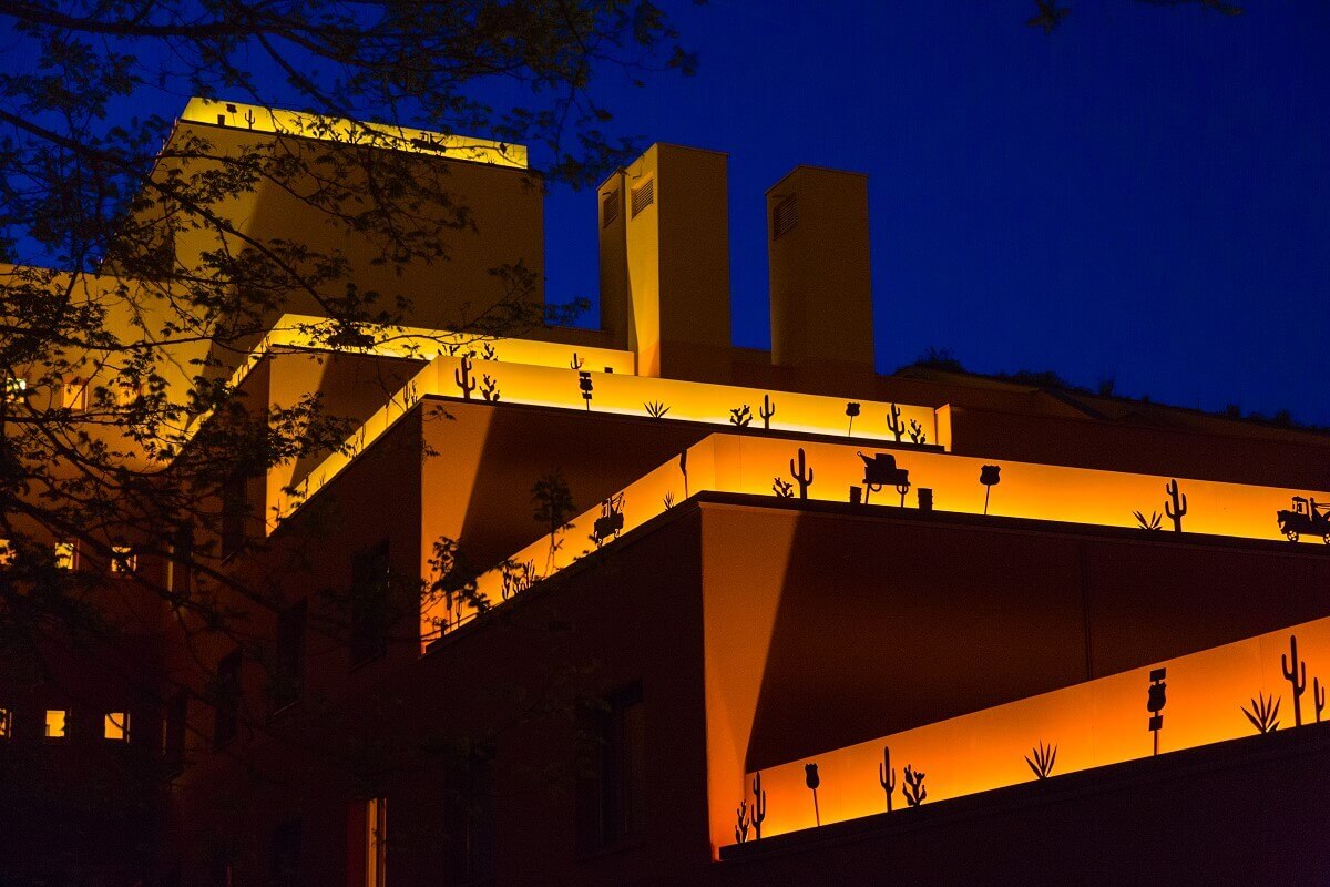 Hotel building Santa Fe by night A hotel building illuminated at night. On the roofs are illuminated borders with motifs from the movie Cars.
