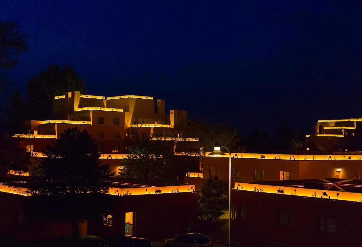 Hotel building Santa Fe by night A hotel building illuminated at night. On the roofs are illuminated borders with motifs from the movie Cars.