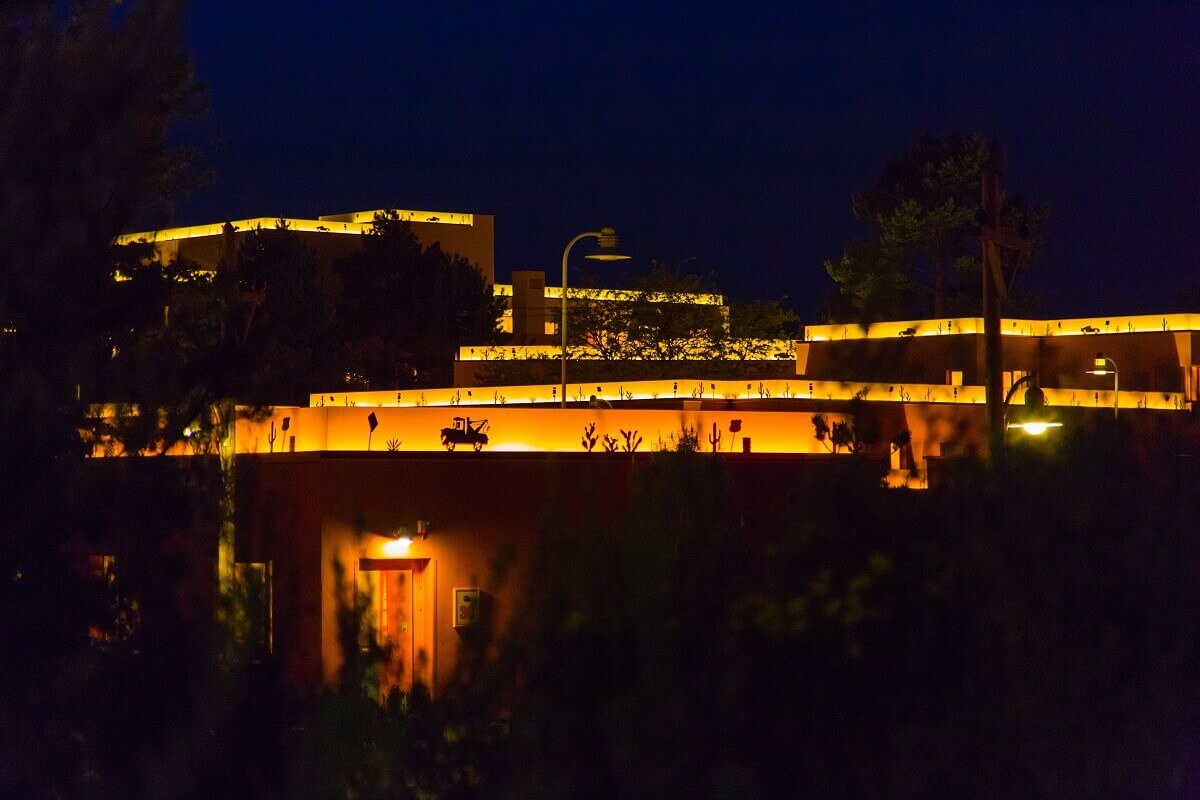 Hotel building Santa Fe by night A hotel building illuminated at night. On the roofs are illuminated borders with motifs from the movie Cars.