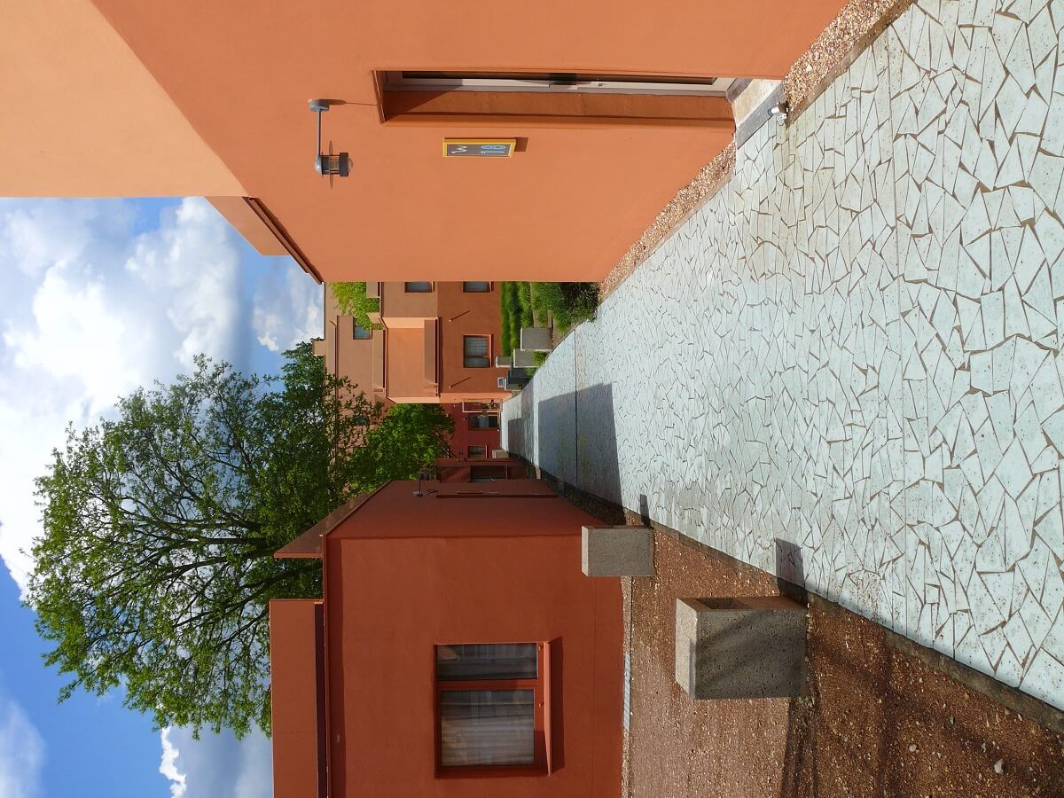 Old hotel buildings A paved path of stones leads through the hotel buildings.