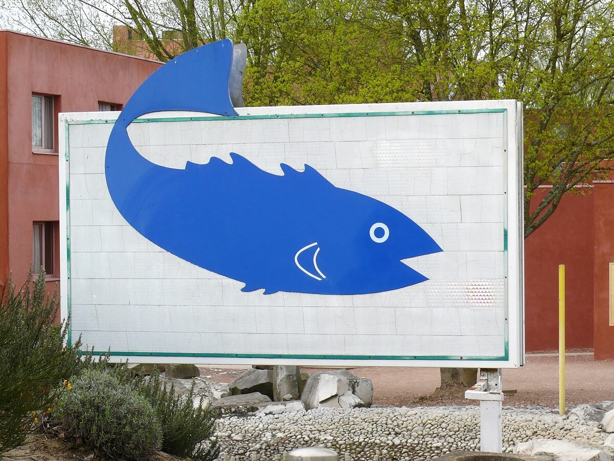 Sign with blue fish A white big sign with a blue fish.