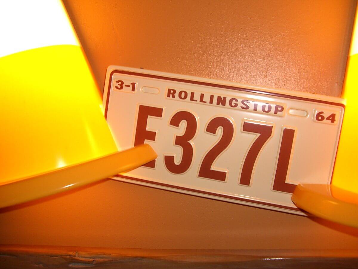 Decoration on the walls A lamp in the shape of pylons and license plates above the bed