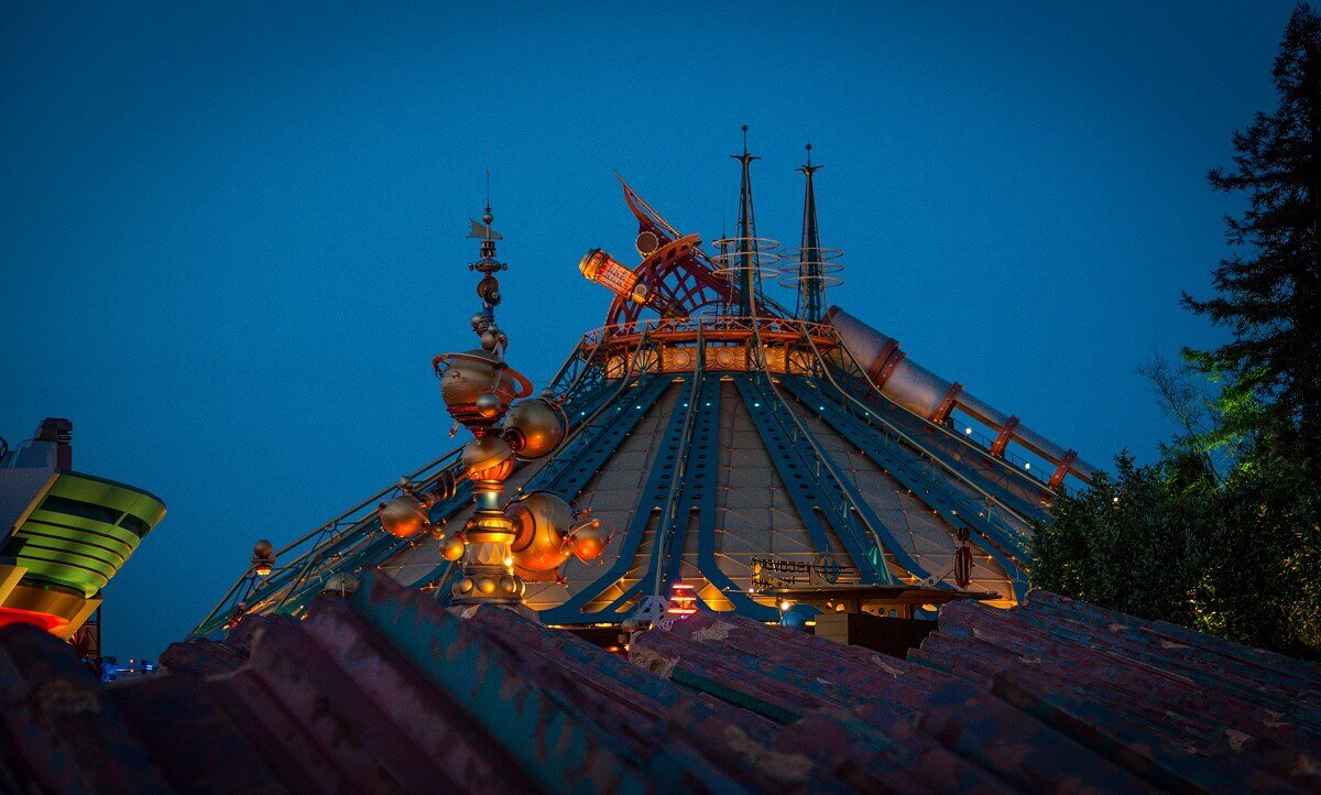 Hyperspace Mountain at dusk View past rock formations to Orbitron and Hyperspace Mountain