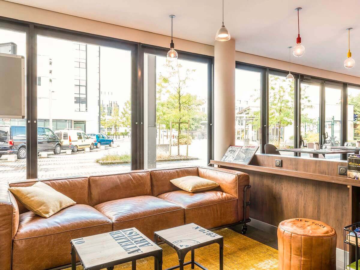 Hotel Lounge Hotel lounge at the Ibis Hotel Val d'Europe with a soda and a view outside.