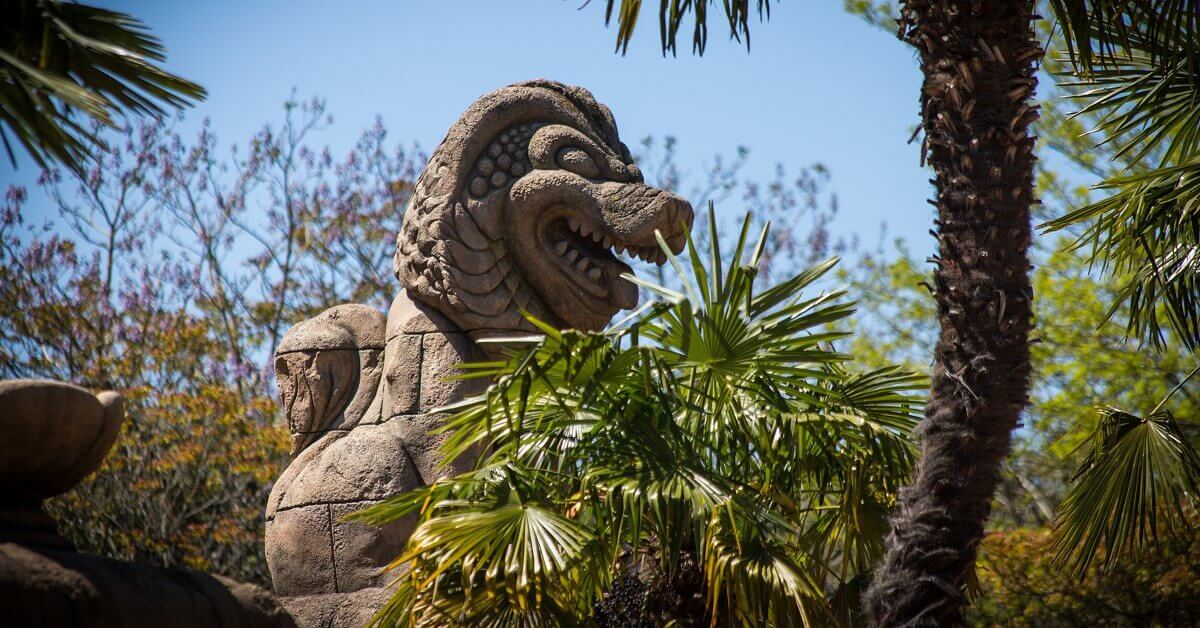 Indiana Jones and the Temple of Peril Roller coaster car behind a lion statue at Indiana Jones and the Temple of Peril
