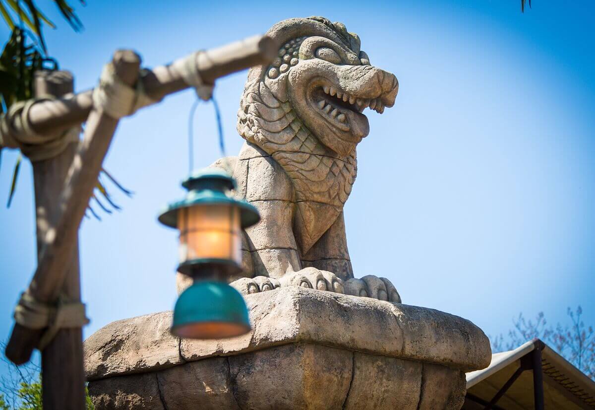 Decoration in the outdoor area of the attraction View past a lantern to a stone animal figure in the temple of danger