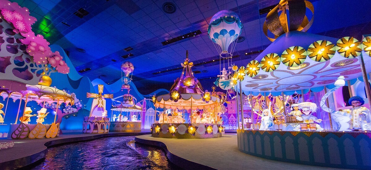Room with carousels at the end of the attraction Its a small world there are many glittering merry-go-rounds with puppets in a space along the water