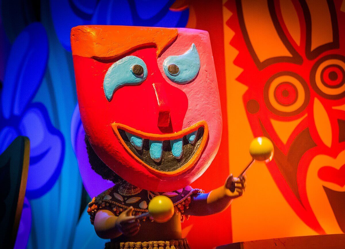 Polynesian Masked Dancer one doll wears a colorful polynesian mask and holds two rattles in his hands