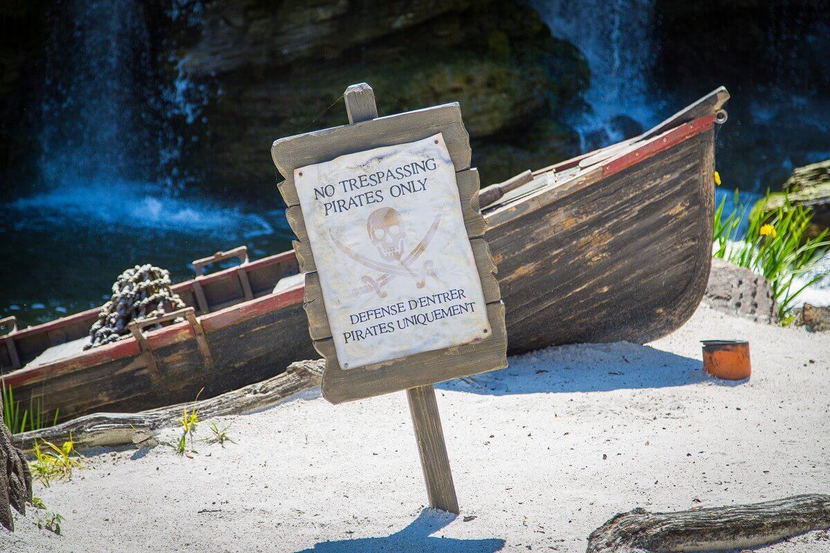 Sign on the beach at the beach near Skull Rock there is a sign in front of a small boat with the inscription No Trespassing Pirates Only