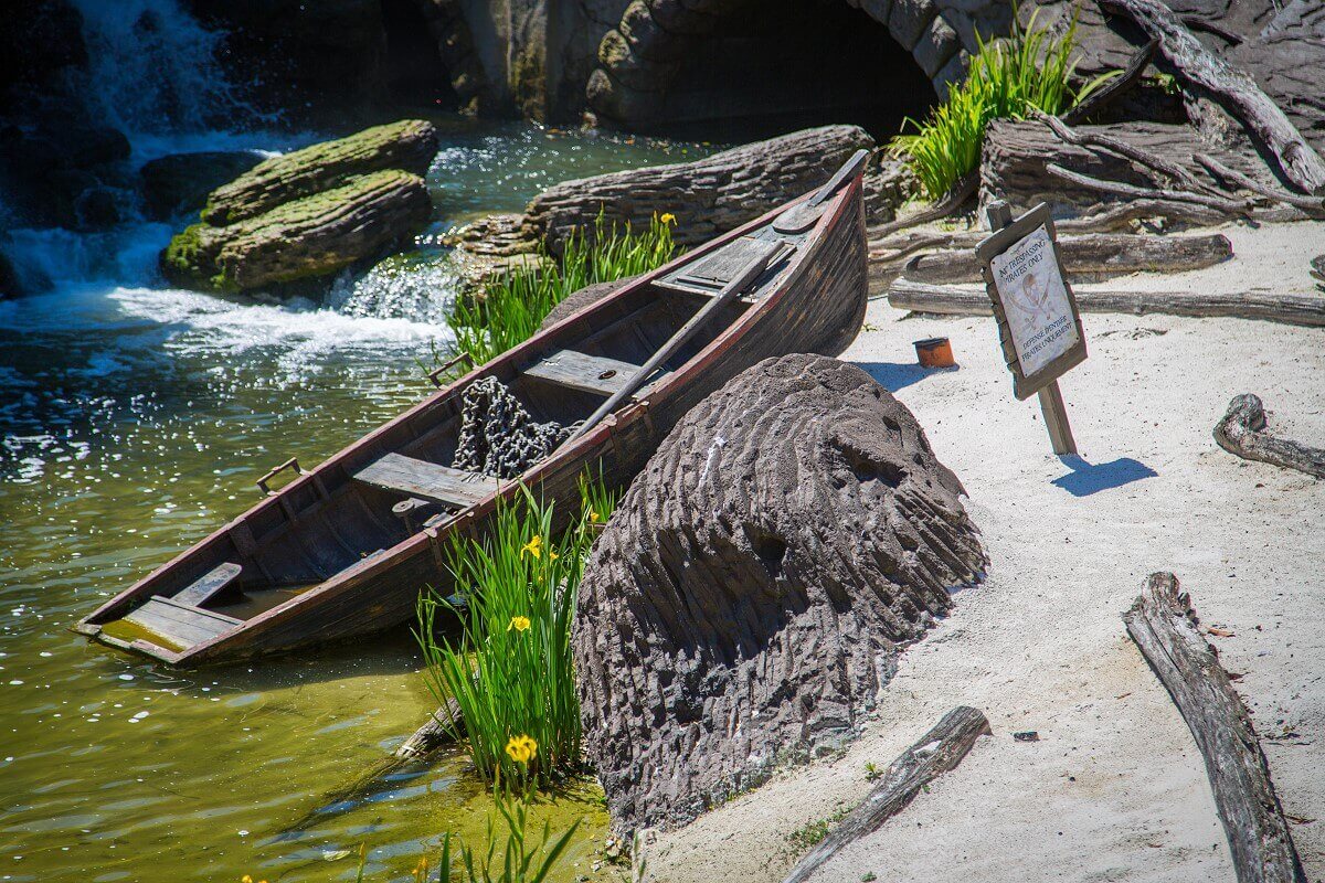 Rowing boat on the beach in Adventureland Side view of the rowboat and flotsam on the beach near Skull Rock