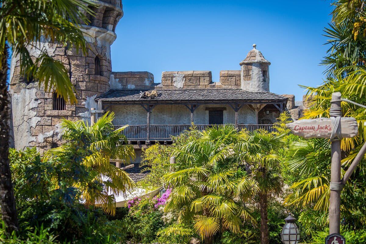 Facade of the Pirates of the Caribbean attraction through dense green you can see the facade of the attraction Pirates of the Caribbean in Adventureland