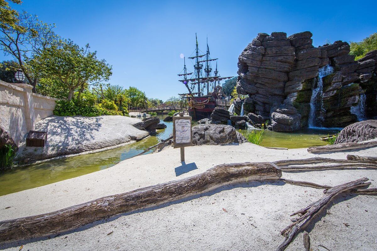 Beach in Adventureland on a beach in the Adventureland lie big tree trunks