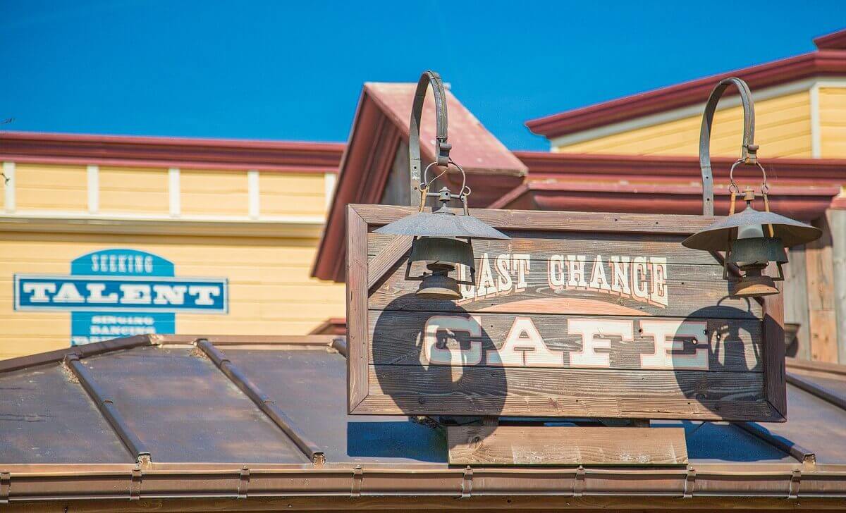 Sign on the roof On the canopy of the Last Chance Café there is a large wooden sign with the name of the restaurant