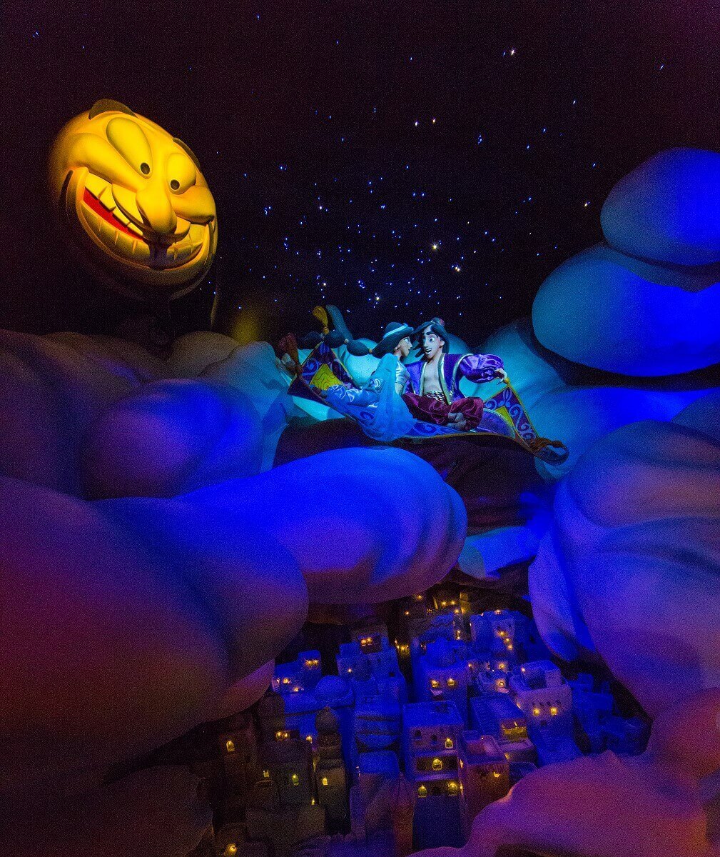 Aladdin and Jasmine above the clouds Aladdin and Jasmine fly by night with the flying carpet over the clouds and the city of Agrabah