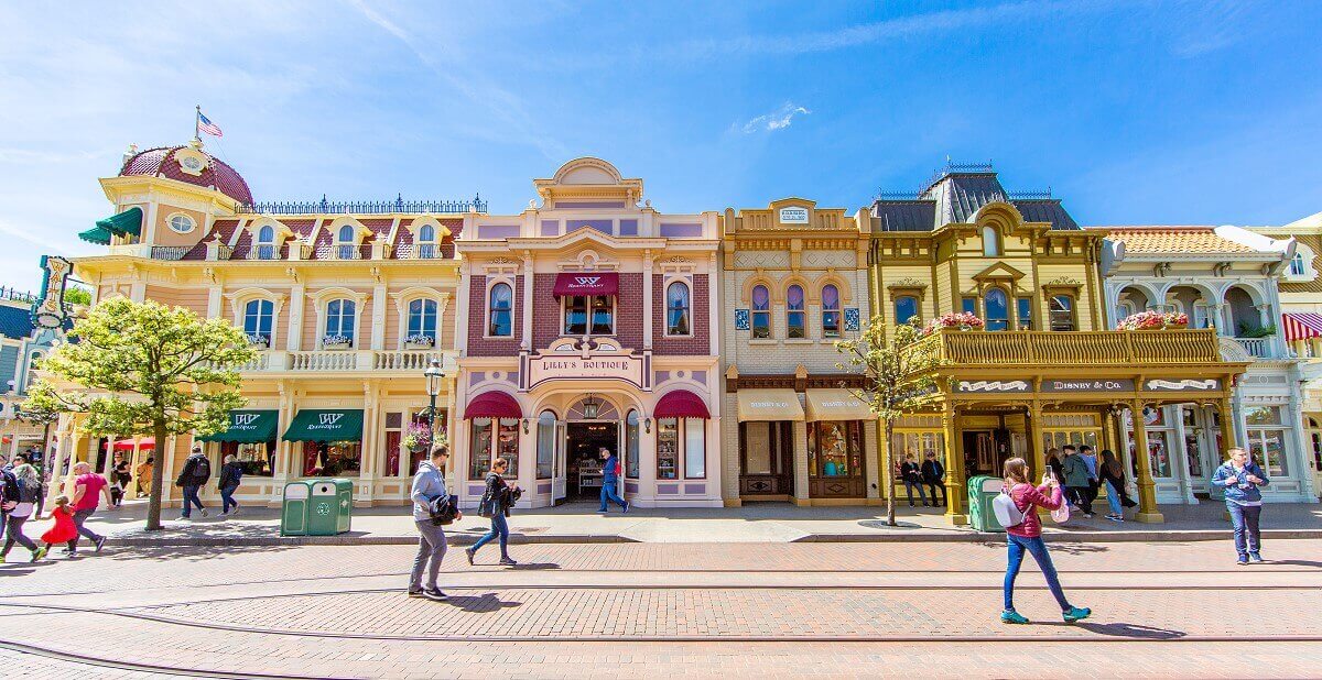 Lilly's Boutique from Main Street Lilly's Boutique from Main Street, Walt's rooms are on the upper floor of the burgundy brick building, and the shop is on the ground floor. Both areas have burgundy awnings on the windows. On the left you can see the building of Walt's - An American Restaurant, on the right that of Disney & Co.