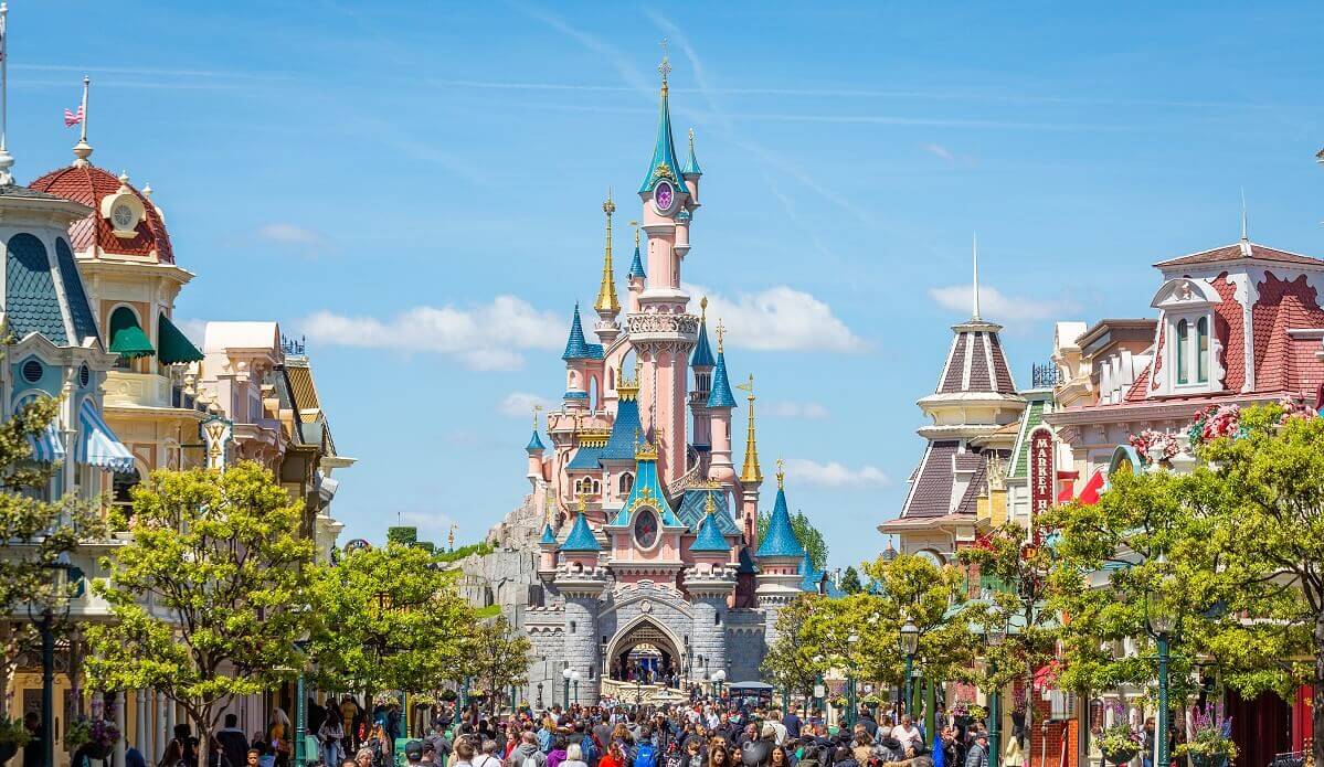 Main Street U.S.A. is heading for Sleeping Beauty Castle Main Street U.S.A. is heading toward Sleeping Beauty Castle, which is framed by the upper floors of Main Street buildings on the right and left in this photo