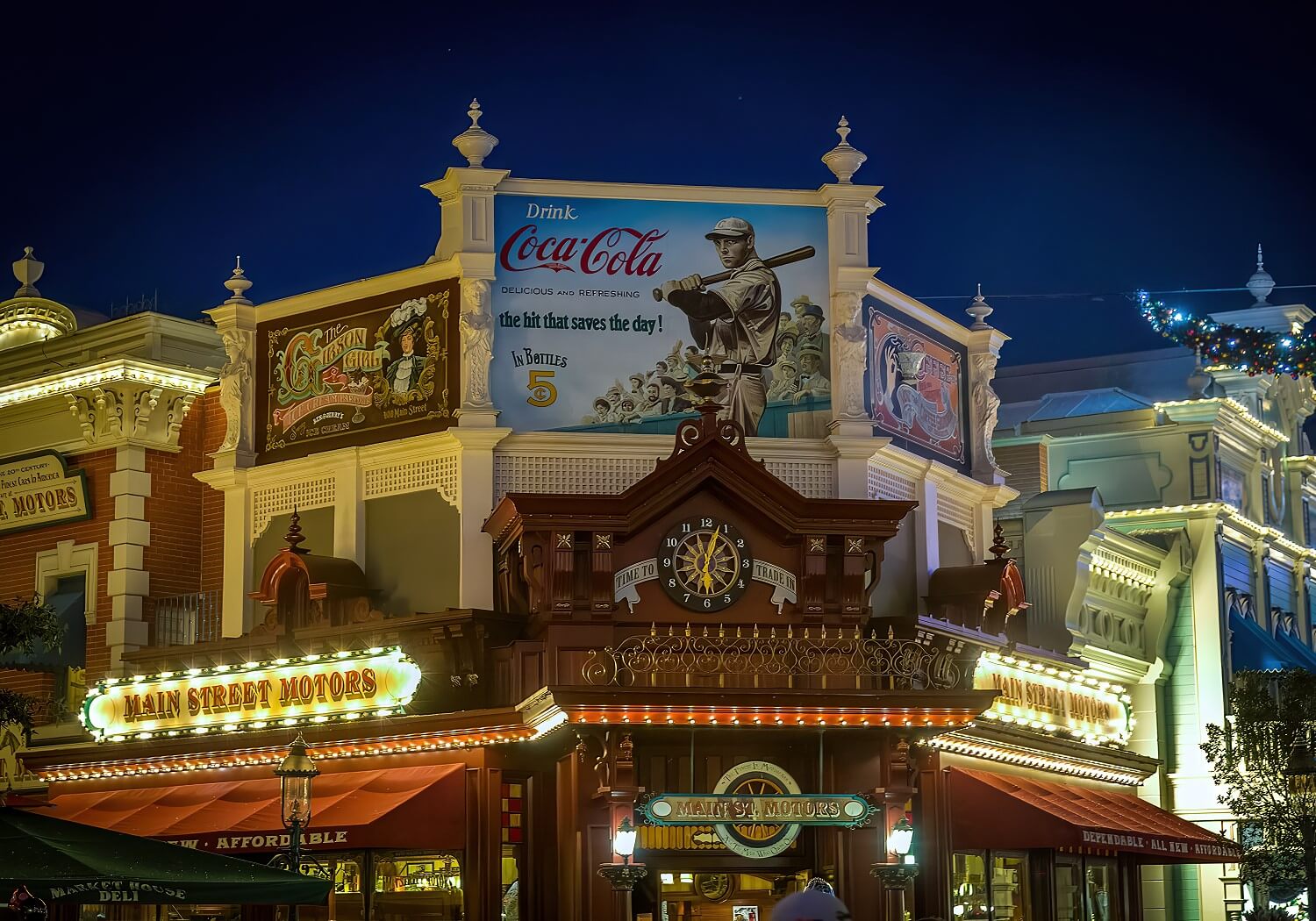 Advertising signs above Main Street Motors at night Advertising signs above Main Street Motors at night. From left to right: Gibson Girl Ice Cram Parlor, Coca Cola with baseball motif, The Coffee Grinder with steaming coffee cup.
