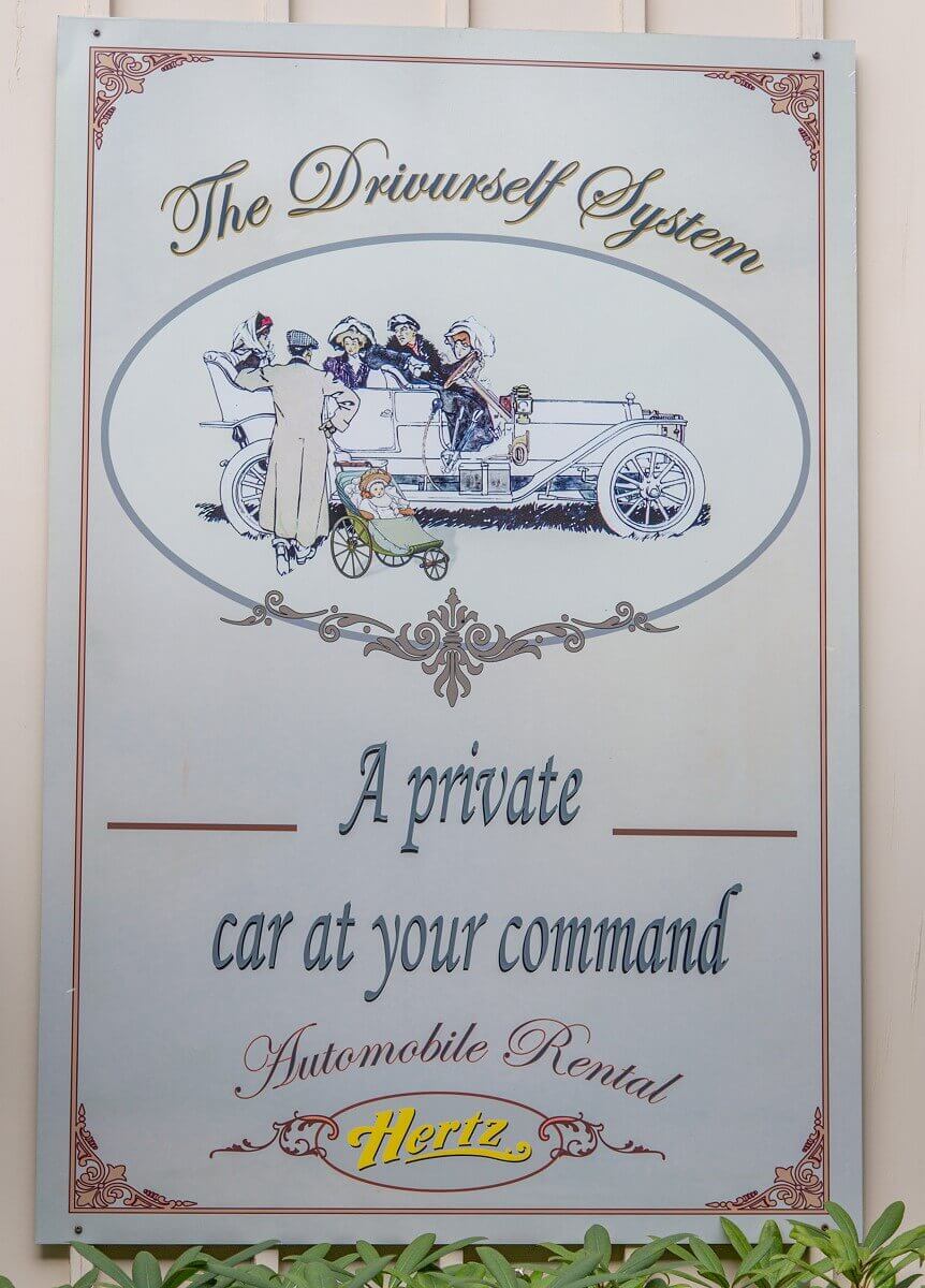 Billboard for Hertz Billboard for Hertz with an elegantly dressed group in a white vintage car and the advertising message: The Drivurself System - A private car at your command