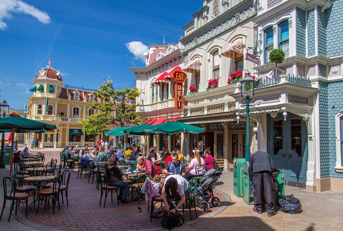 Outdoor area of the Market House Deli Outdoor area of Market House Deli in front of the restaurant on Market Street, with green chairs and umbrellas. In the background, the facade of Walt's on the other side of Main Street.