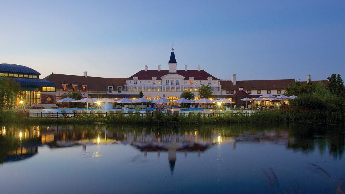 Marriot Village Ile de France View from the lake to the pool of the Marriott Village at dusk