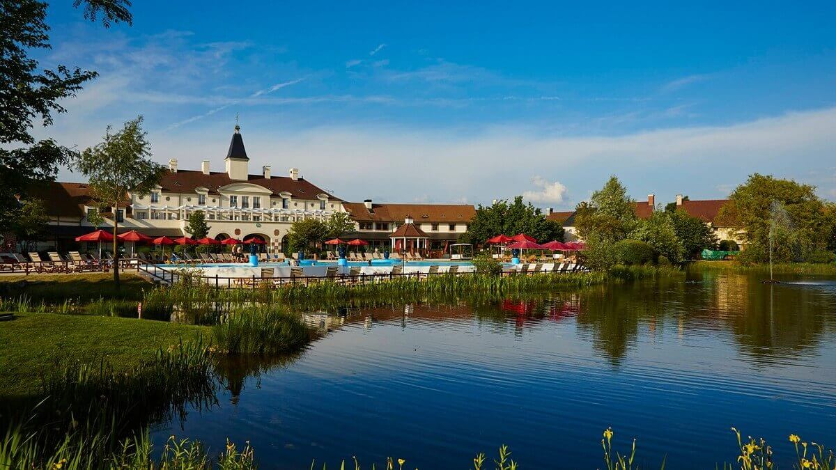 Hotel with pool View from the lake to the outdoor pool of the Marriott Village Hotel at Disneyland Paris