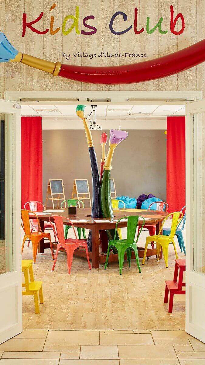 Kids Club in the hotel Large painting and craft table in the Kids Club with colourful chairs