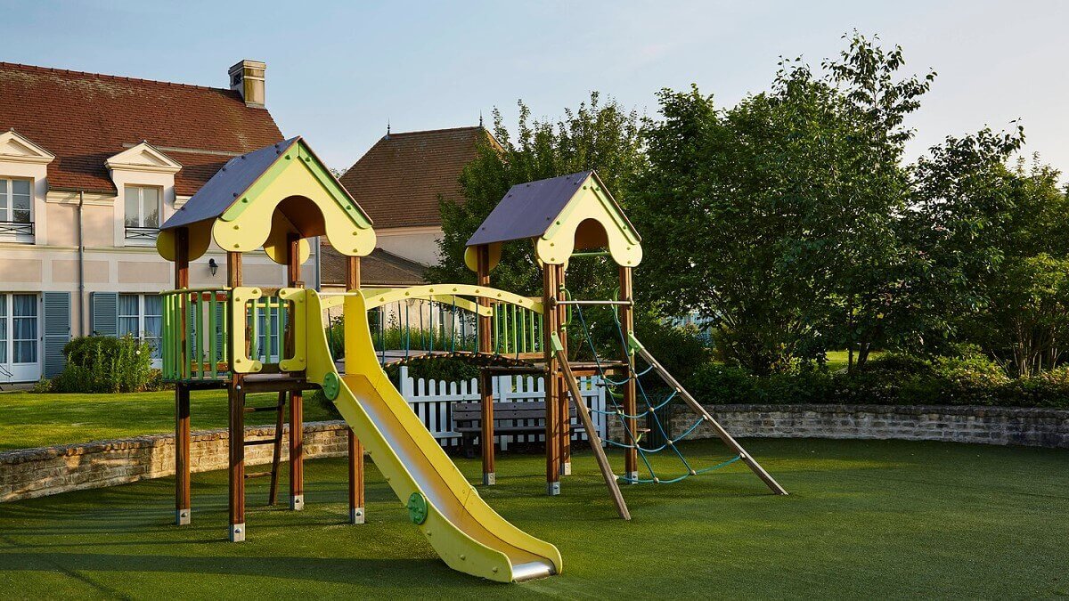 Playground Climbing frame and slide in the shape of a castle on the playground of the Marriott Village Hotel