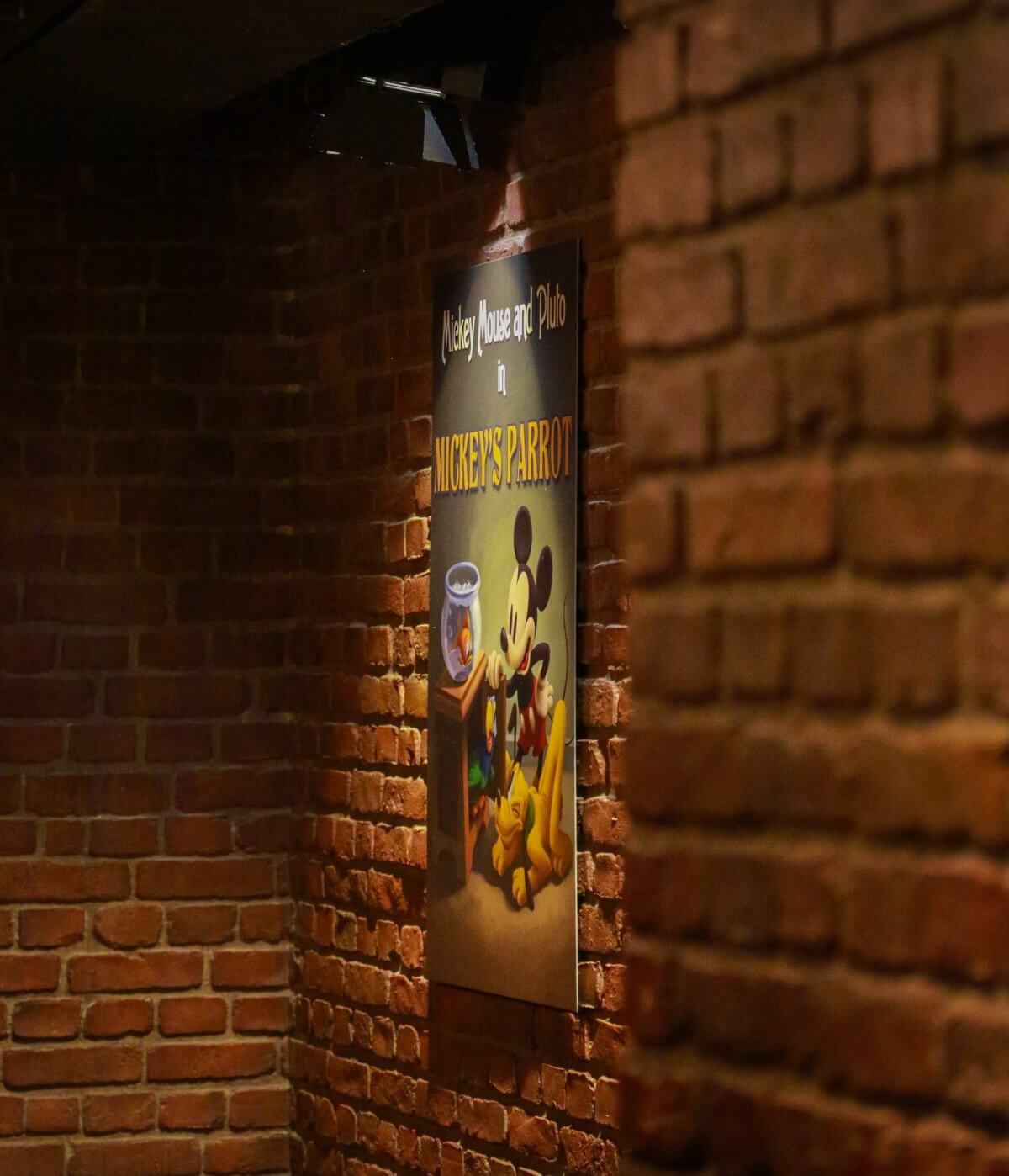 Waiting area for a meeting with Mickey Mouse View of a brick wall with a poster hung on it for a short film with Mickey