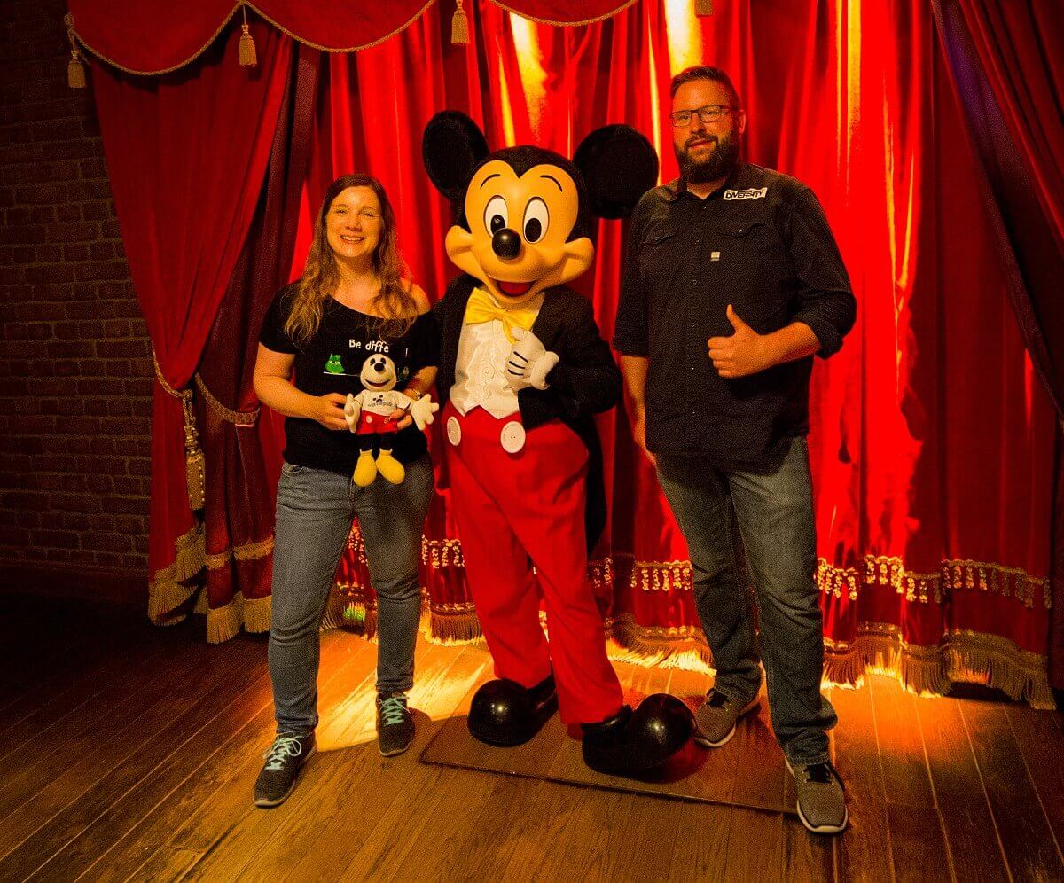 Shared photo with Mickey Dörthe and Torsten from dein-dlrp pose together with Mickey in the pavilion of Meet Mickey Mouse