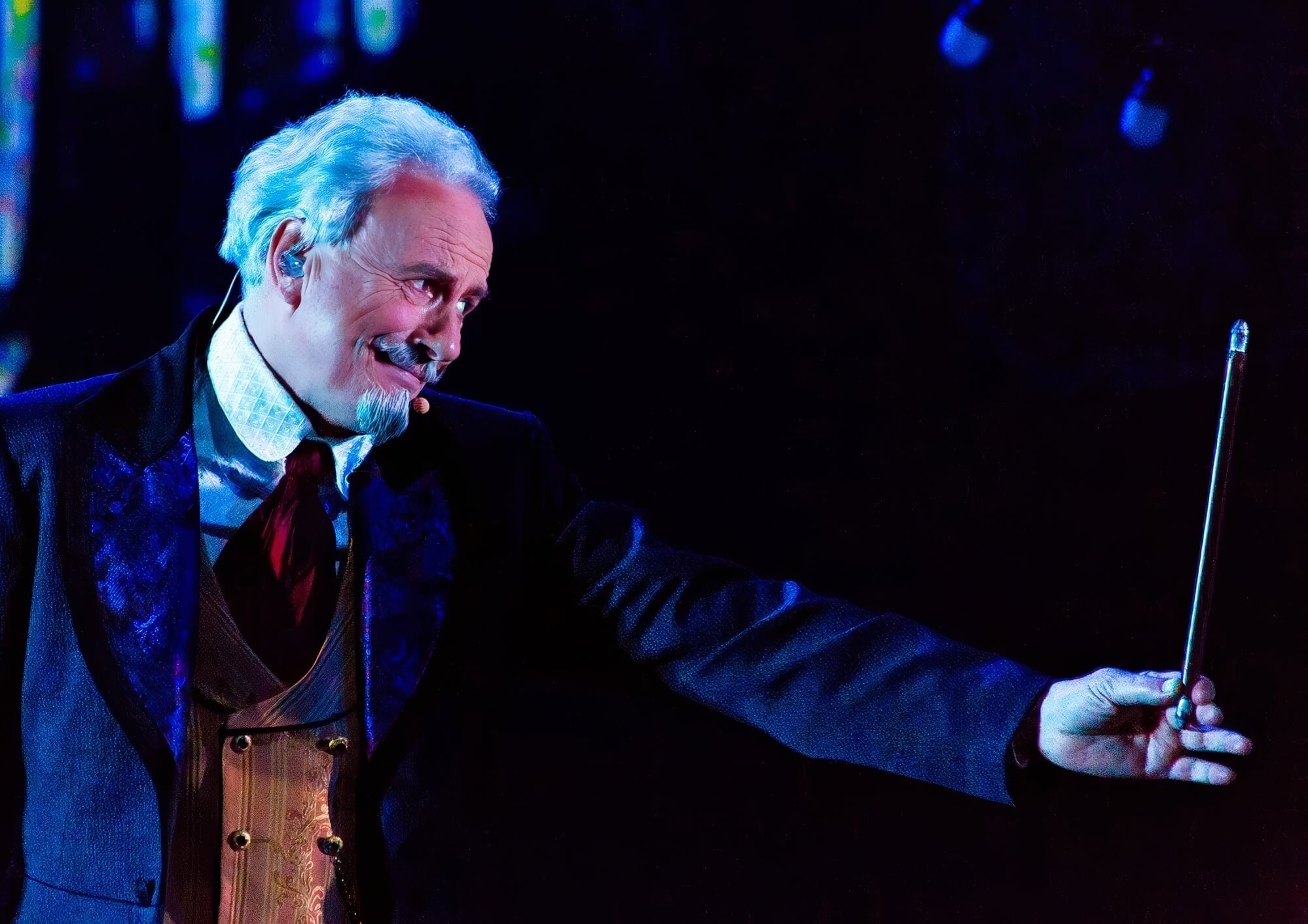 The Wizard hands Mickey a magic wand The gracious and friendly looking wizard hands Mickey a wand