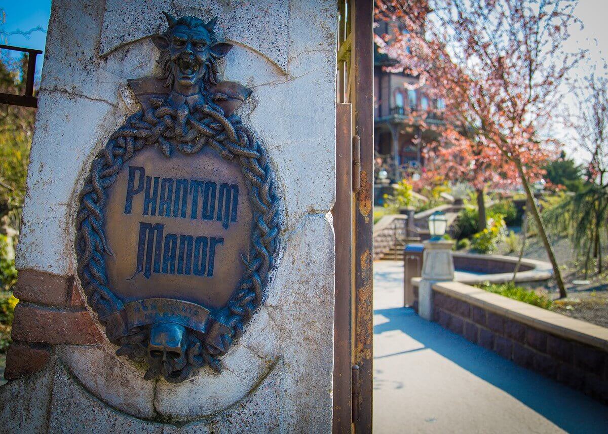 Entrance area Phantom Manor Sign with the inscription Phantom Manor at the entrance of the attraction