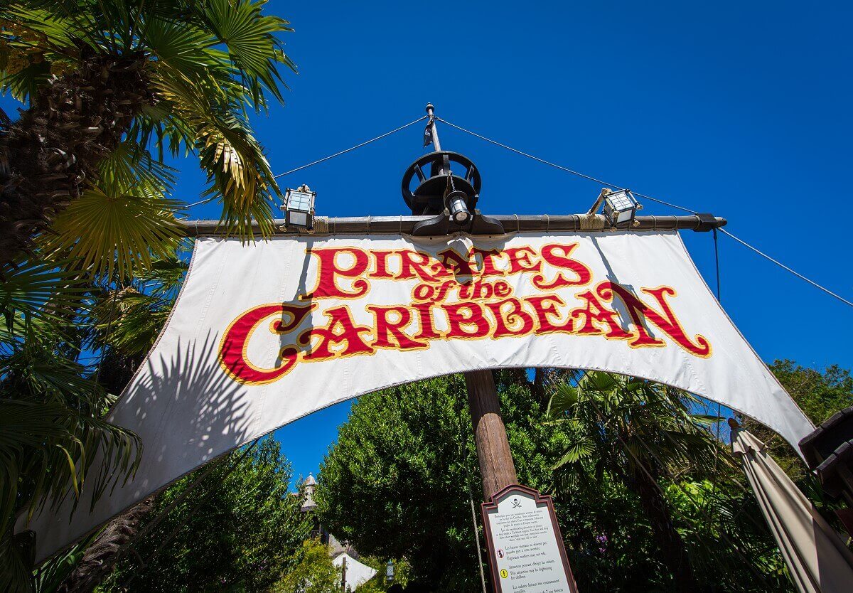 Sail over the entrance to the Pirates of the Caribbean above the entrance is a sail with the inscription Pirates of the Caribbean stretched