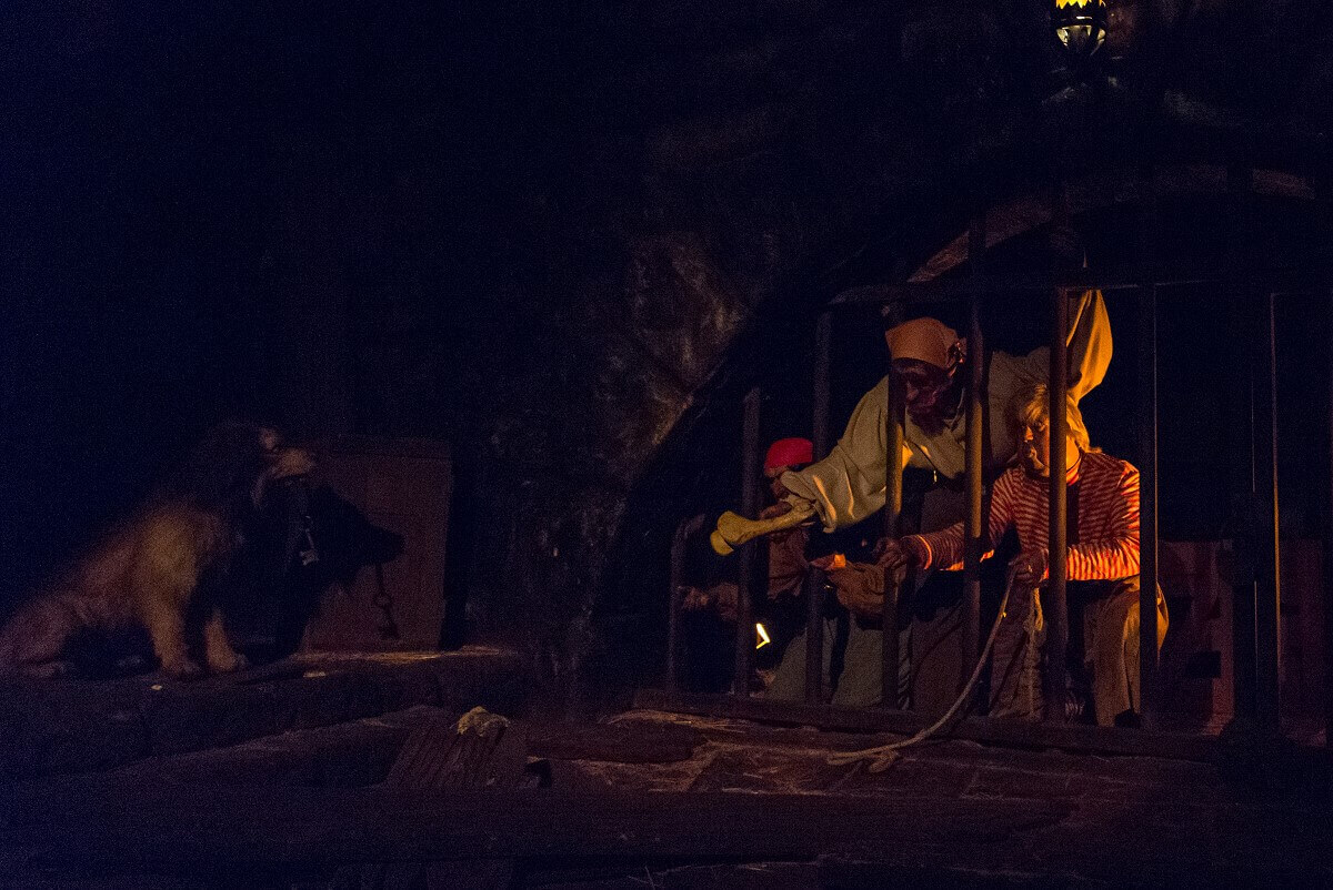 Imprisoned pirates in jail three pirates locked in a prison cell try to lure a dog with keys to them with the help of a bone