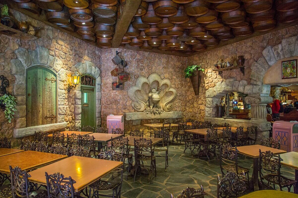 Seats at the Pizzeria Bella Notte Some tables and chairs stand in a room with wine barrels hanging from the ceiling