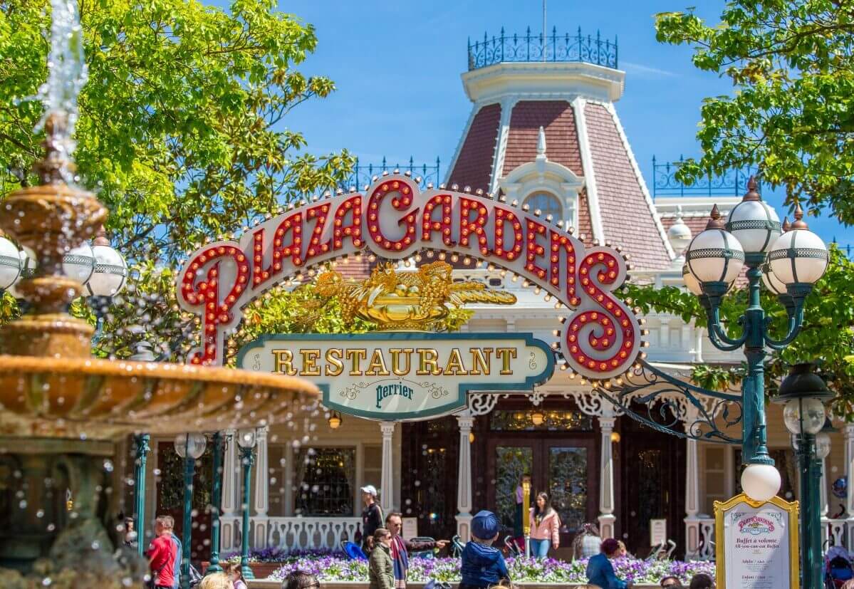 Entrance sign of the Plaza Gardens Restaurant The red, light bulb entrance sign to the Plaza Gardens Restaurant, with a fountain in front of it.