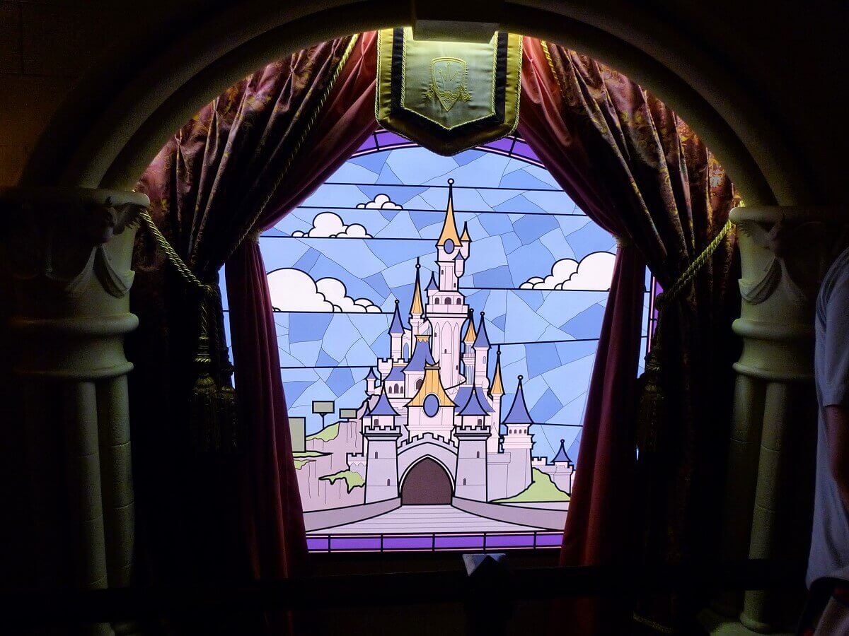 Aurora's castle on a stained glass window The Sleeping Beauty Castle is visible on a beautifully designed stained glass window