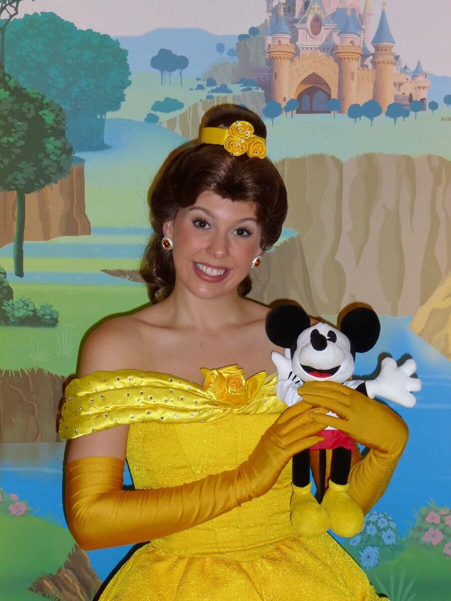 Belle and the boss Belle from Disney's Beauty and the Beast poses with the boss plushie in the princess pavilion