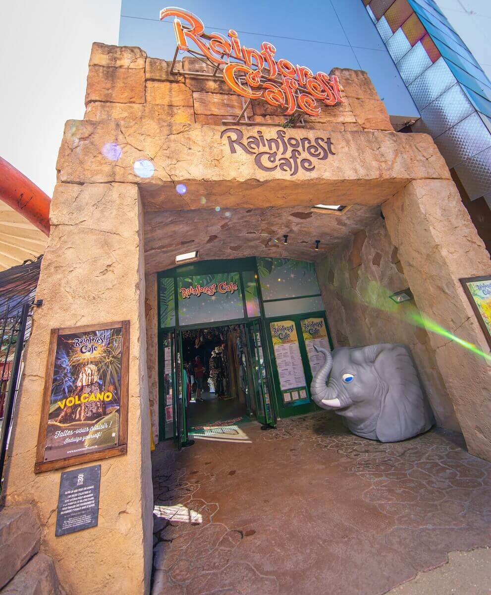 Main entrance of the Rainforest Cafe at Disney Village Main entrance of the Rainforest Cafe at Disney Village, designed like an ancient temple, with the elephant platform on the right where you can check in