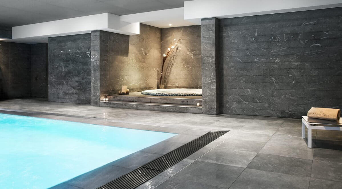 Hotel pool Stylish hotel pool with tiles in granite look, slightly set off a whirlpool