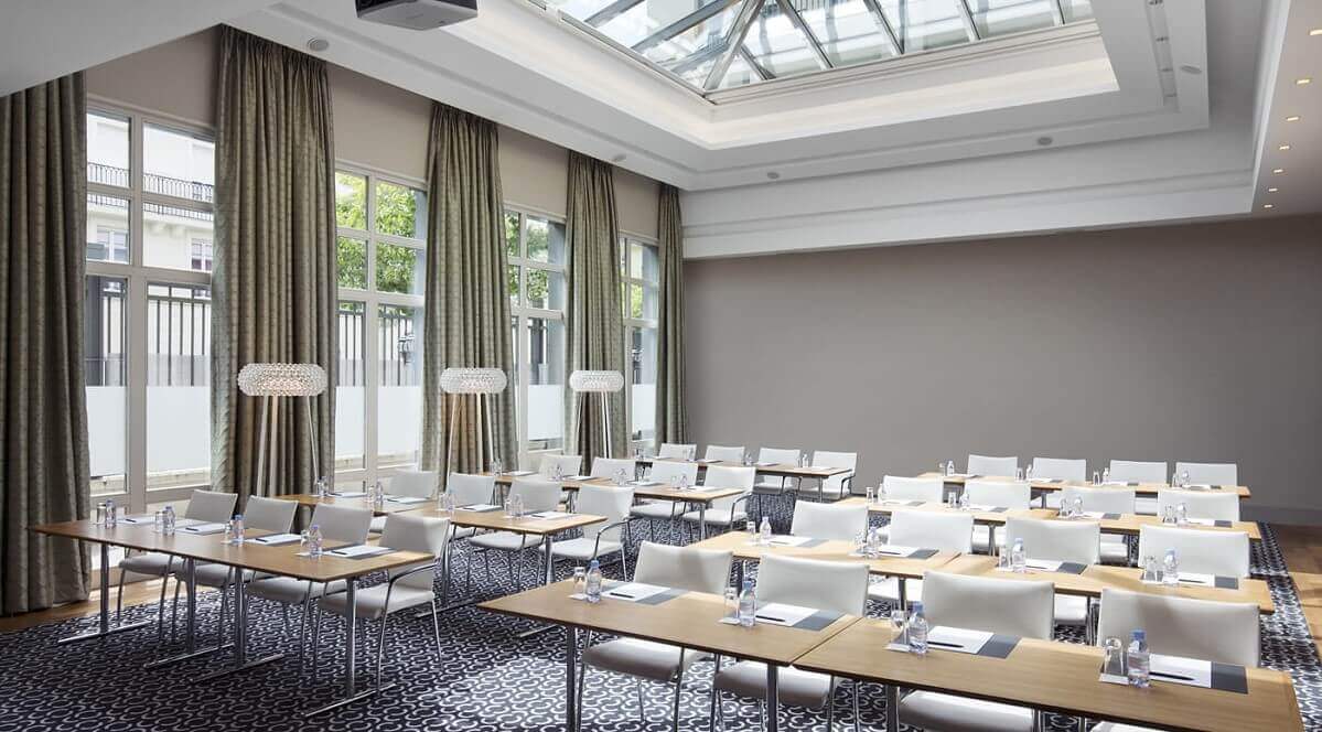 Conference Room Light-flooded conference room in the Relais Spa Hotel with rows of tables and white chairs